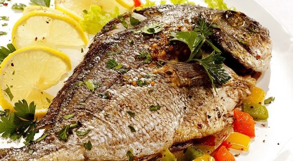 Baked carp with vegetables