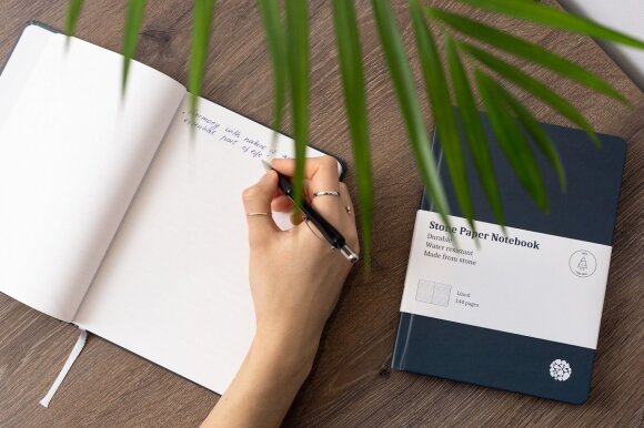 You can write on rock paper with several pens, only the ink does not absorb and has to dry